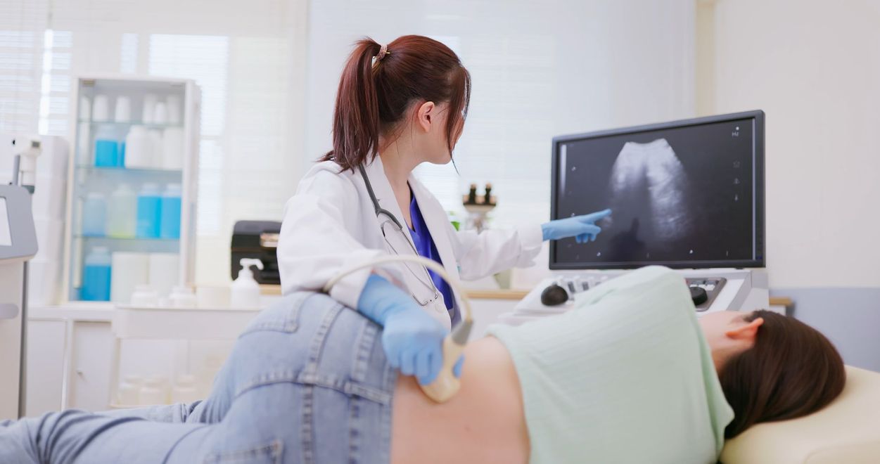 Doctor Performing Ultrasound on A Patient Lying Down — Highland, UT — Renal Associates of Montgomery PC Doctor Performing Ultrasound on A Patient Lying Down — Highland, UT — Renal Associates of Montgomery PC