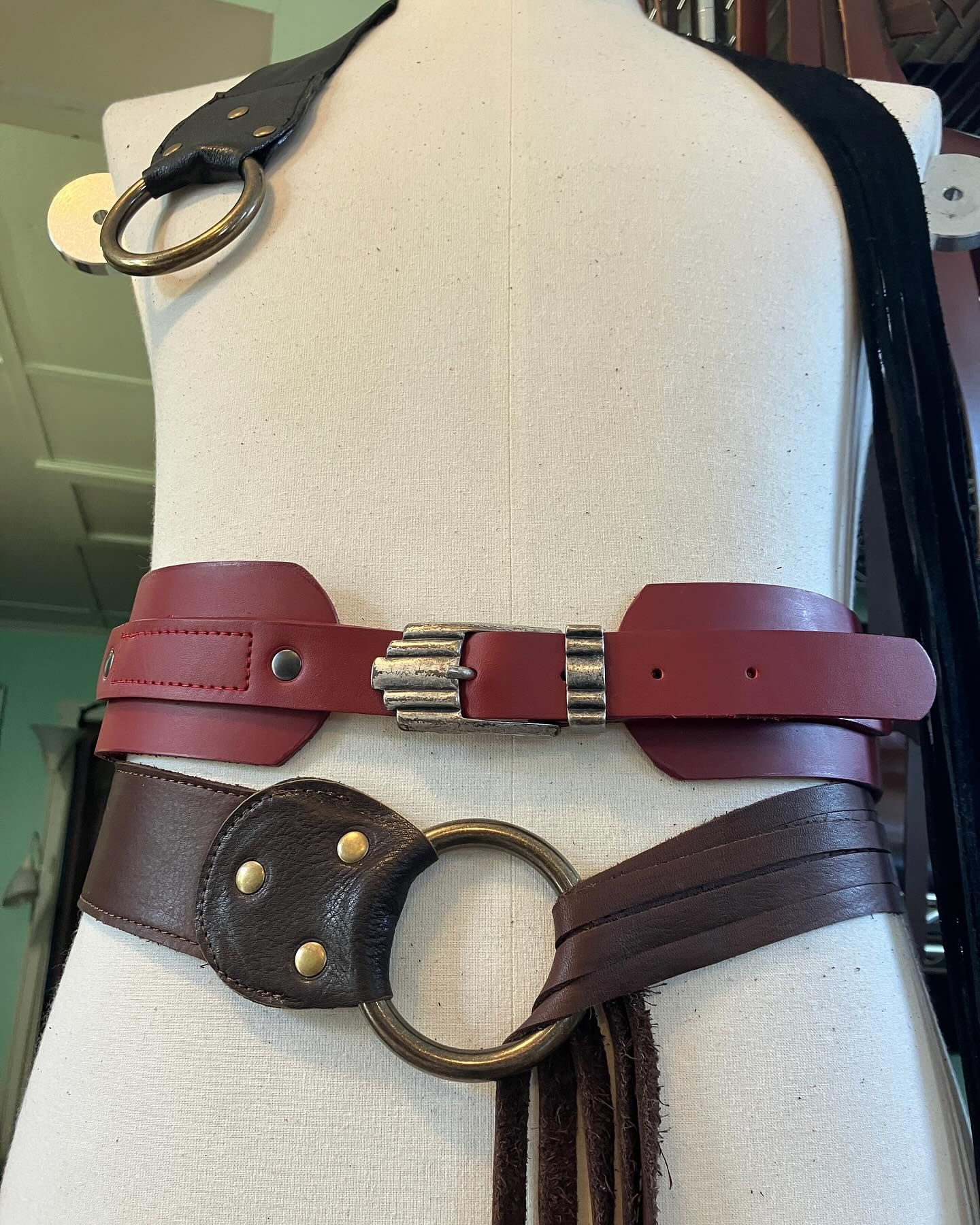 Various leather belts on a mannequin