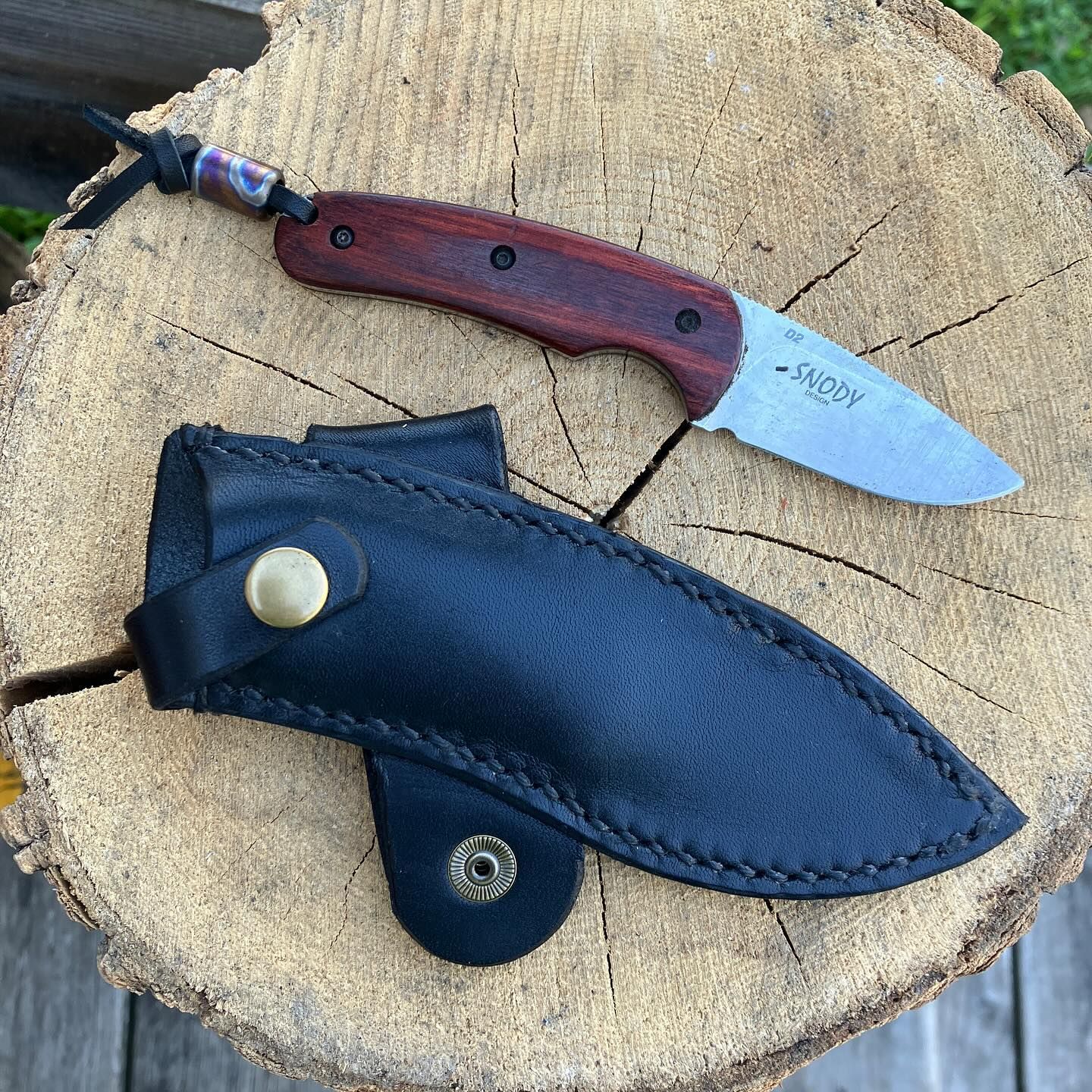 Sharpened knife with a leather sheath