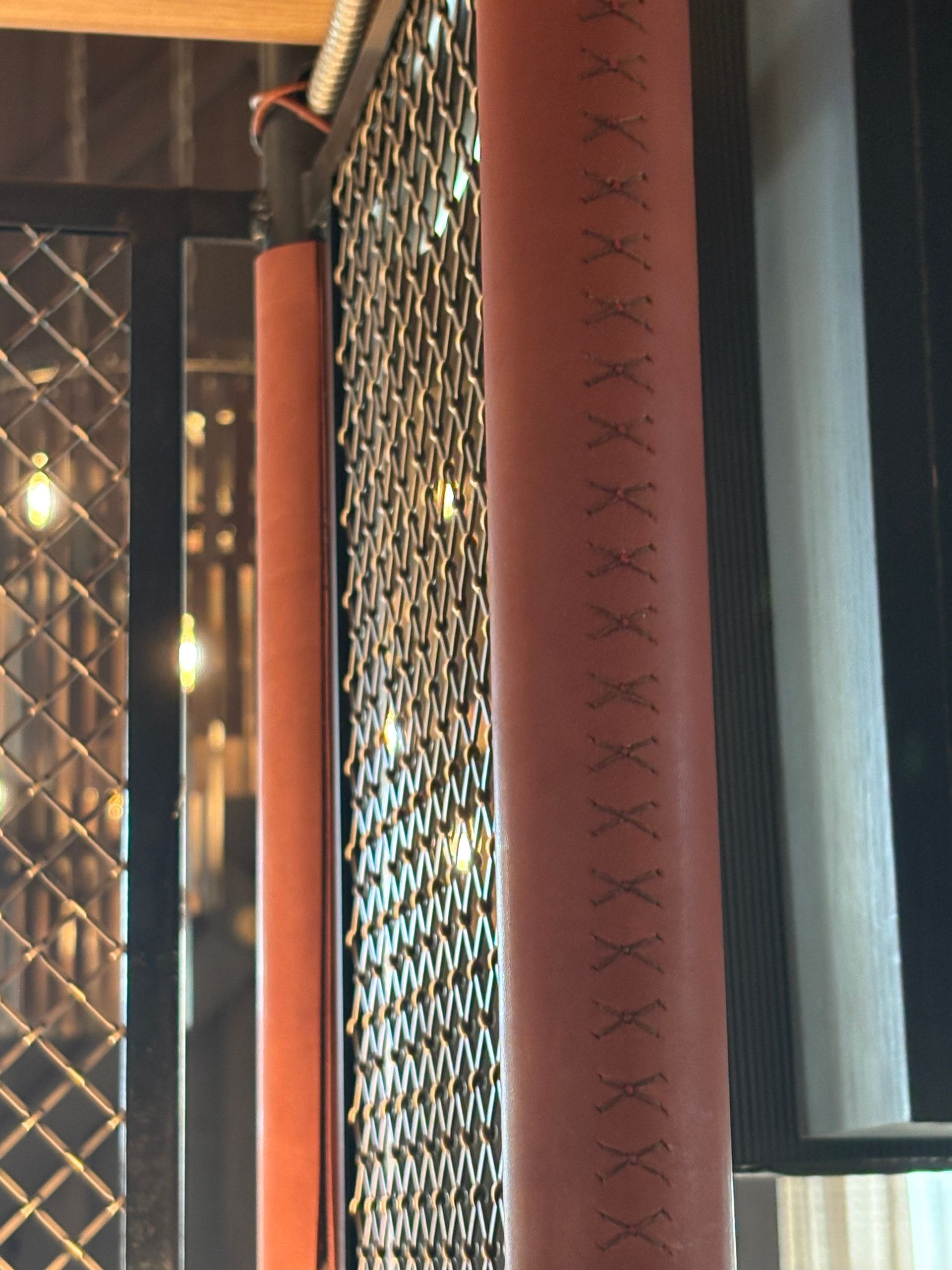 Hand stitching on leather wrapped shelf