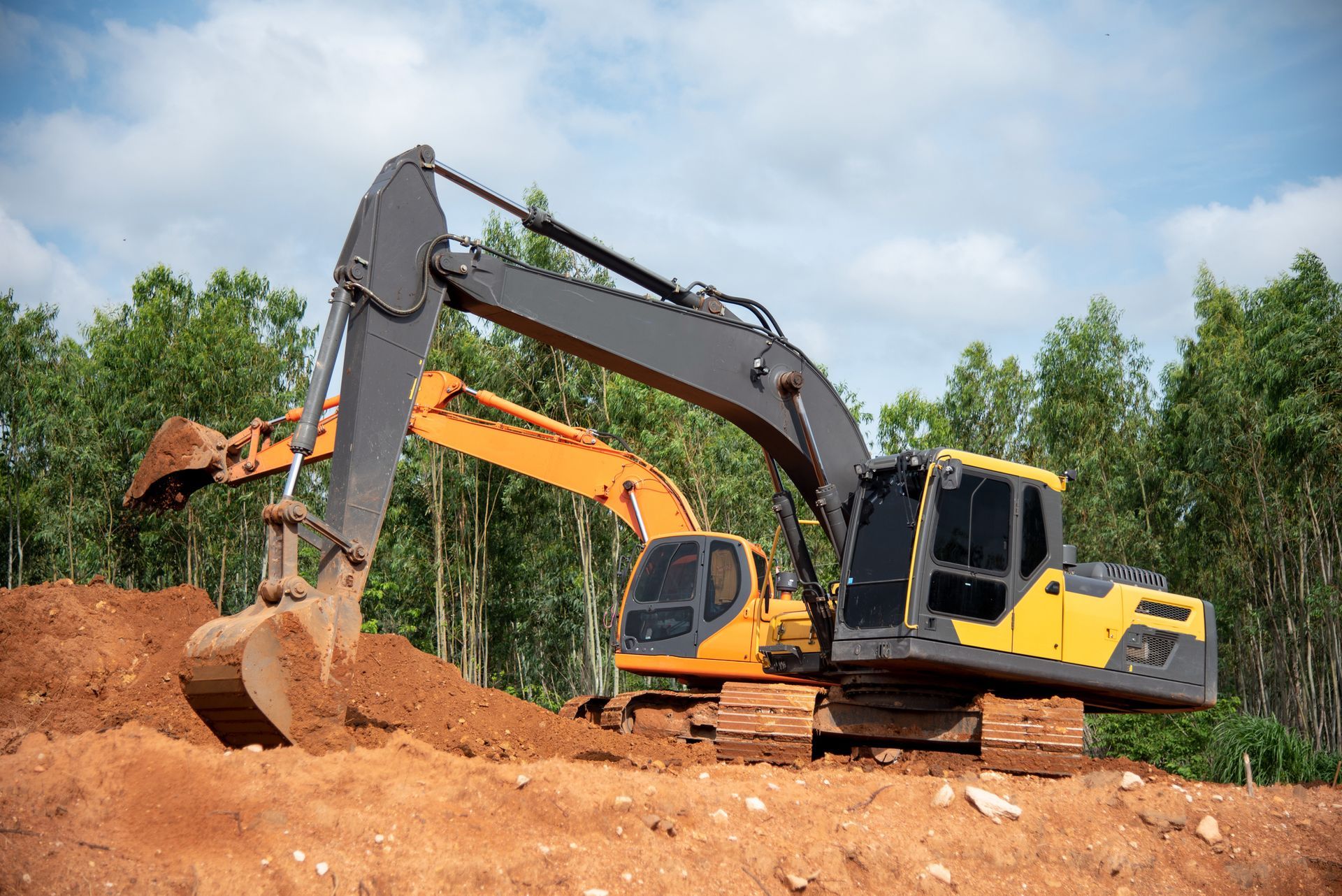Two excavators are working on a construction site.