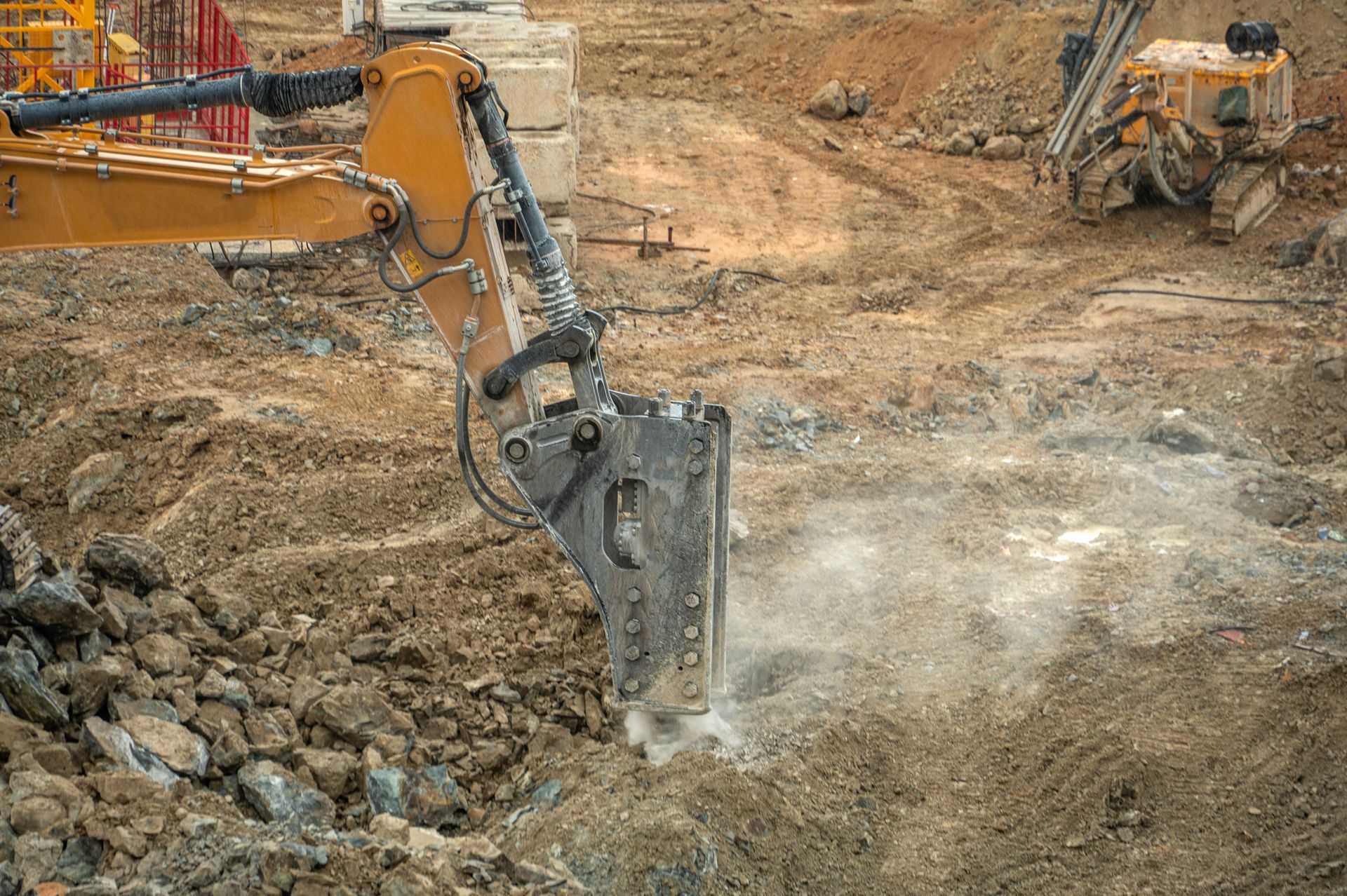 A bulldozer is digging a hole in the ground at a construction site.