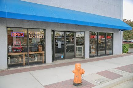 Storefront with a blue awning, glass doors and windows; a fire hydrant is in front.