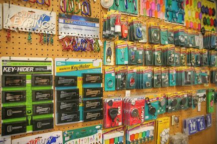 Pegboard displaying various key-related items: keyrings, key hiders, and key blanks. Pegboard displaying various key-related items: keyrings, key hiders, and key blanks.