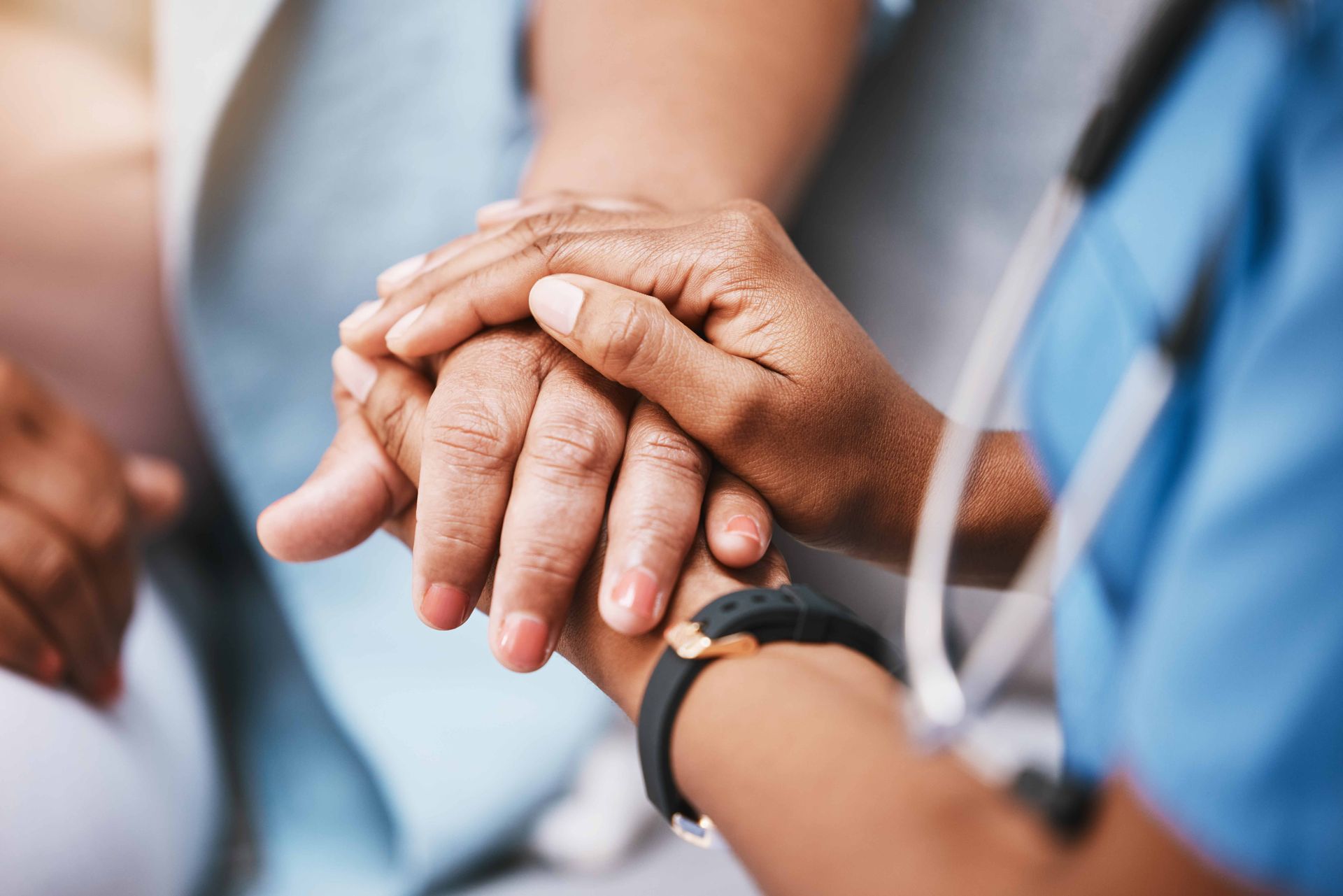 A nurse holding hands with patient for help, consulting support and healthcare advic