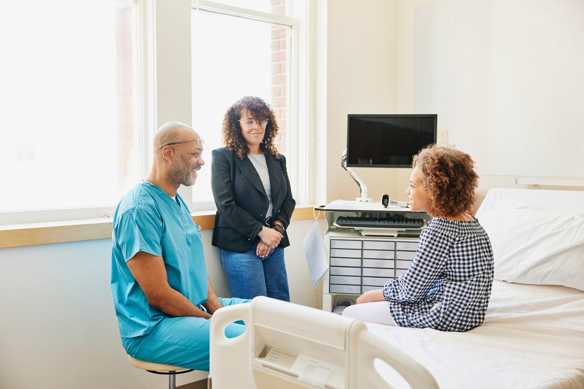 Doctor Consulting Patient In Hospital Room