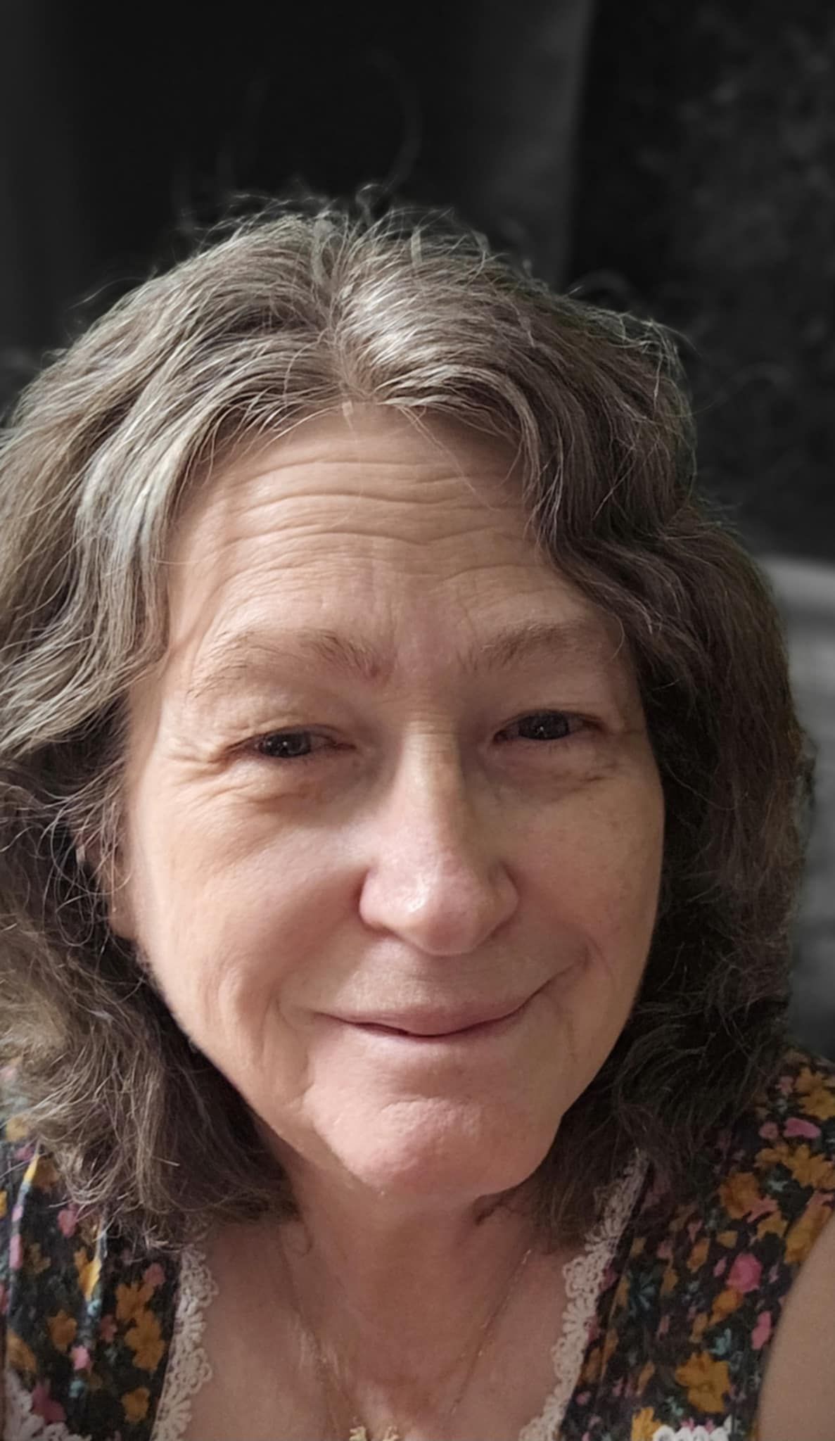 A close up of a woman with a smile on her face.
