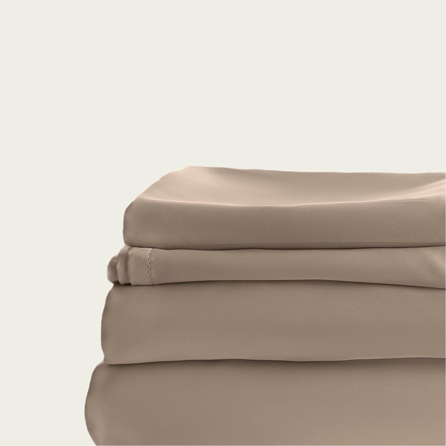 A stack of beige sheets sitting on top of each other on a white background.