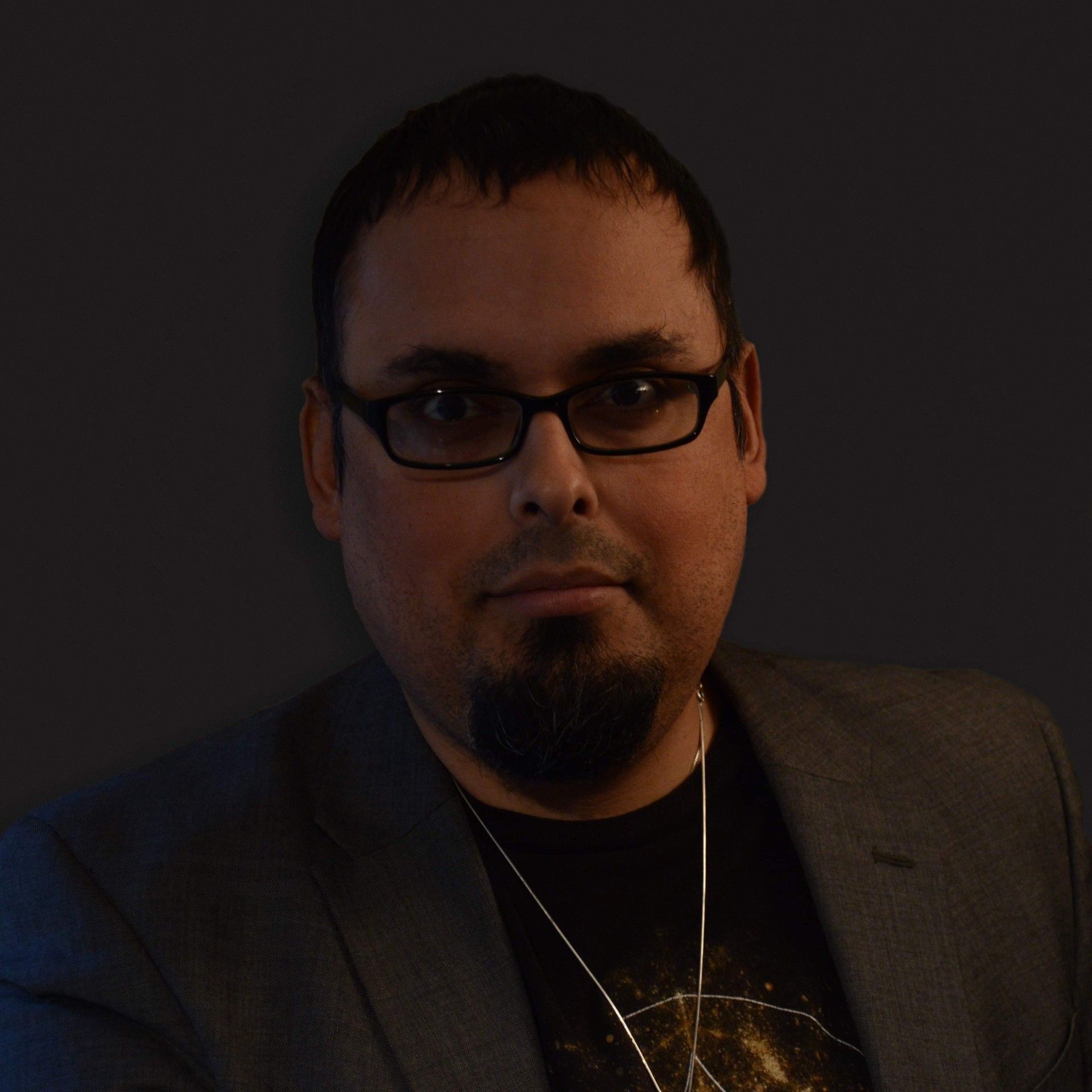 A man wearing a hat and glasses is a certified member of the Spiritual Professionals association