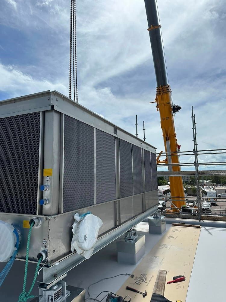 A Crane is Lifting a Large Air Conditioner — Great Northern Airconditioning & Mechanical Services in Berrimah, NT
