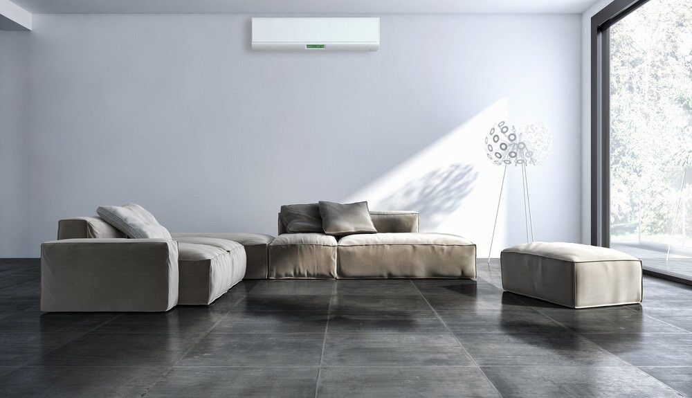 Living Room With Couch, Ottoman, and Aircon — Great Northern Airconditioning & Mechanical Services in Casuarina, NT