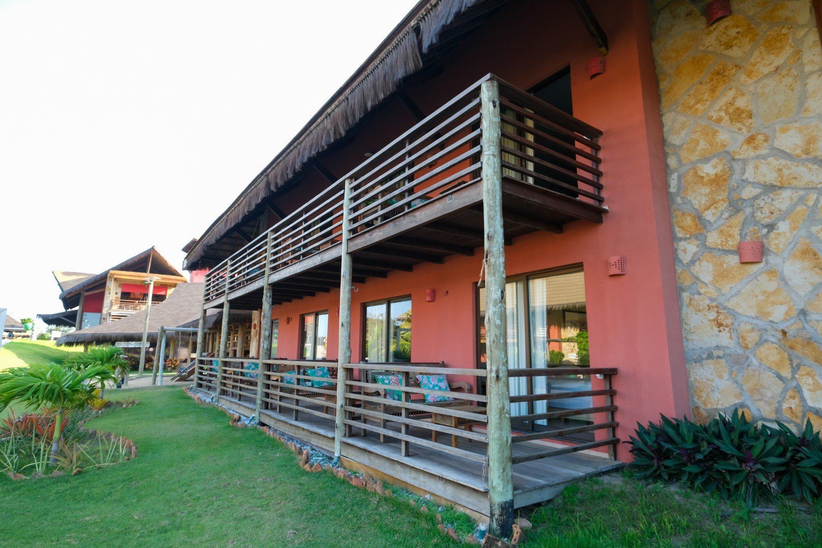 Um prédio com uma varanda e um muro de pedra