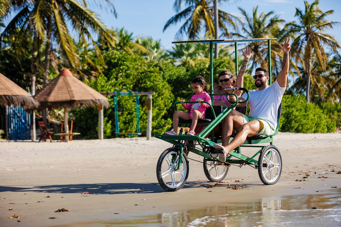 Três pessoas andam de bicicleta na praia em Luís Correia no Piauí