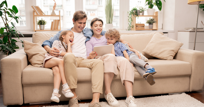 An image showing a happy family sitting together, representing affordable insurance in Spartanburg, SC.