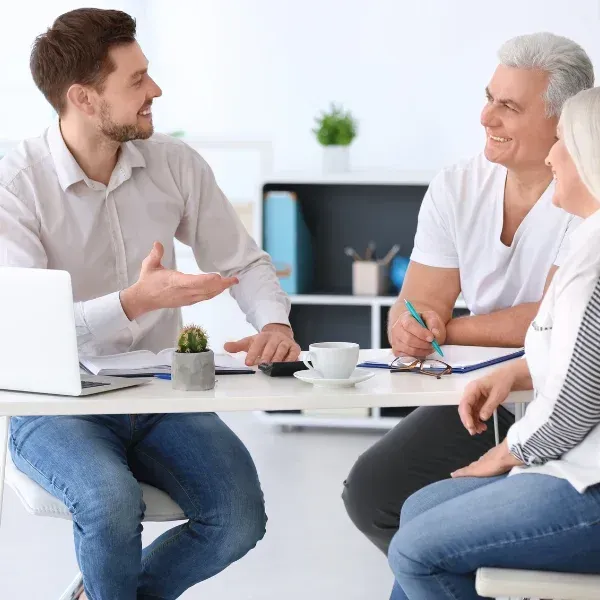An image showing a family with a financial advisor discussing whole life insurance.
