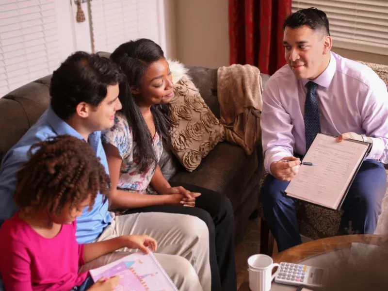 An image showing a family discussing life insurance quotes with an advisor.