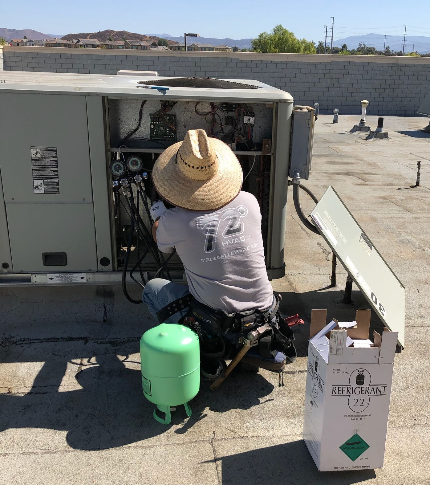 72 Degrees HVAC technician servicing rooftop HVAC equipment