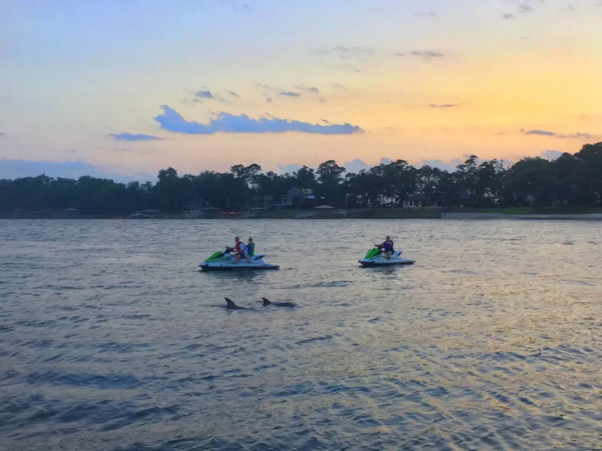 A group of people are riding jet skis on a lake.