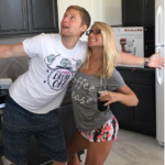 A man and a woman are standing next to each other in a kitchen.