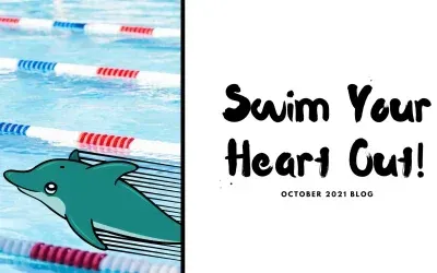 A dolphin is swimming in a pool next to a sign that says swim your heart out.
