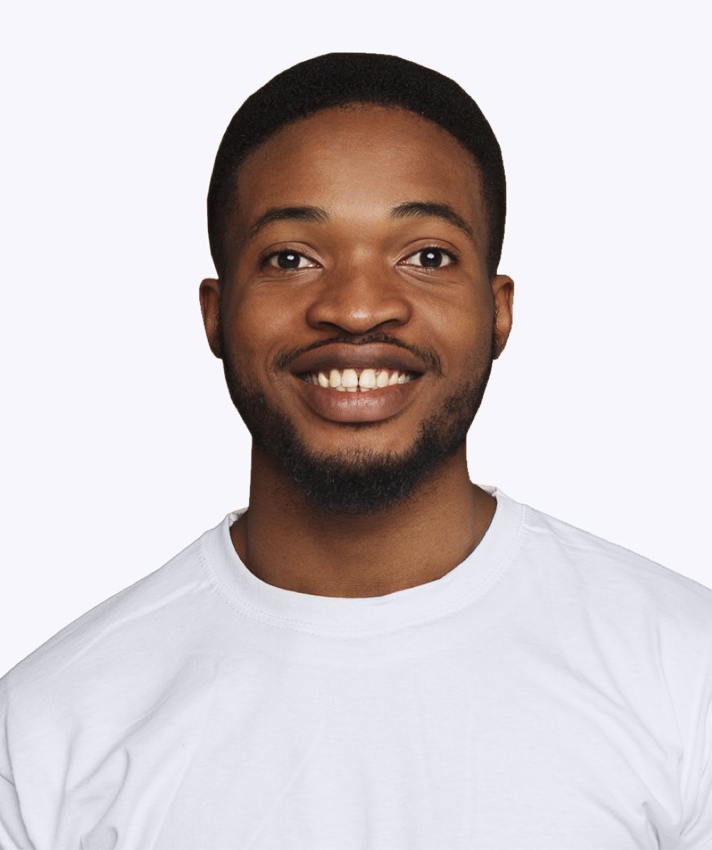 Smiling person wearing a white shirt against a white backdrop.