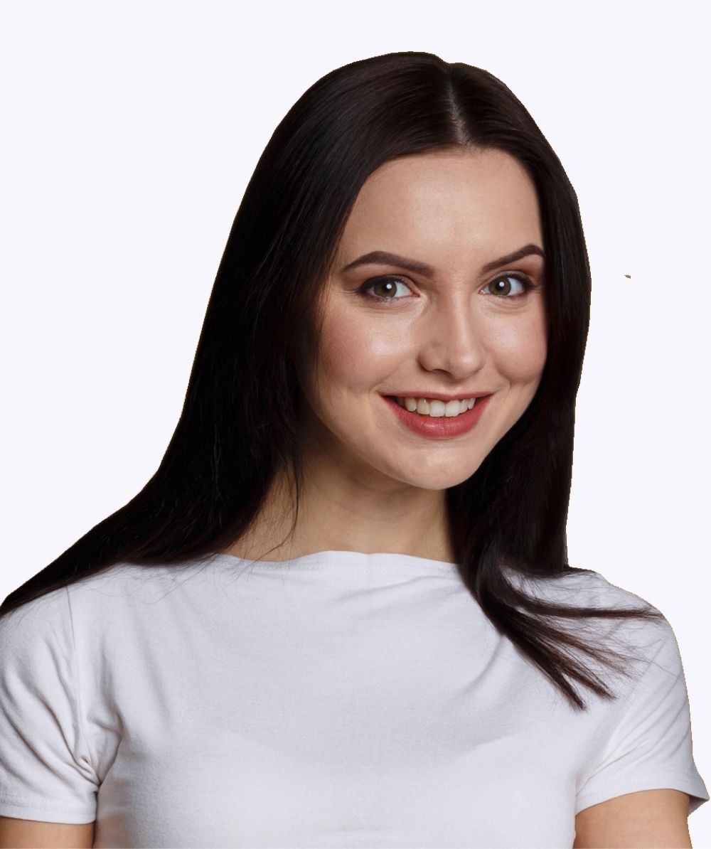 Woman with dark hair smiling, wearing a white t-shirt.