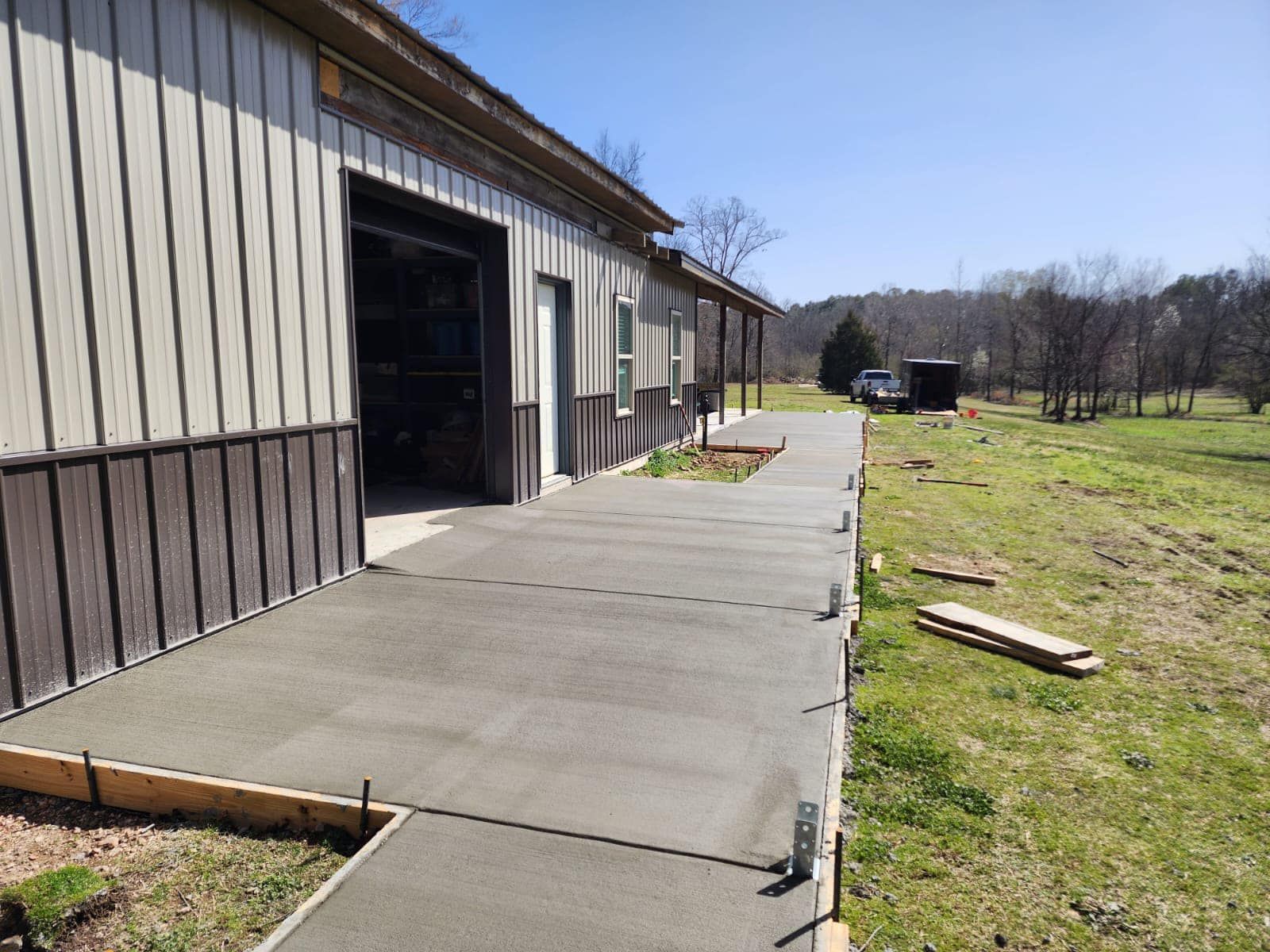 A concrete walkway is being built in front of a building.