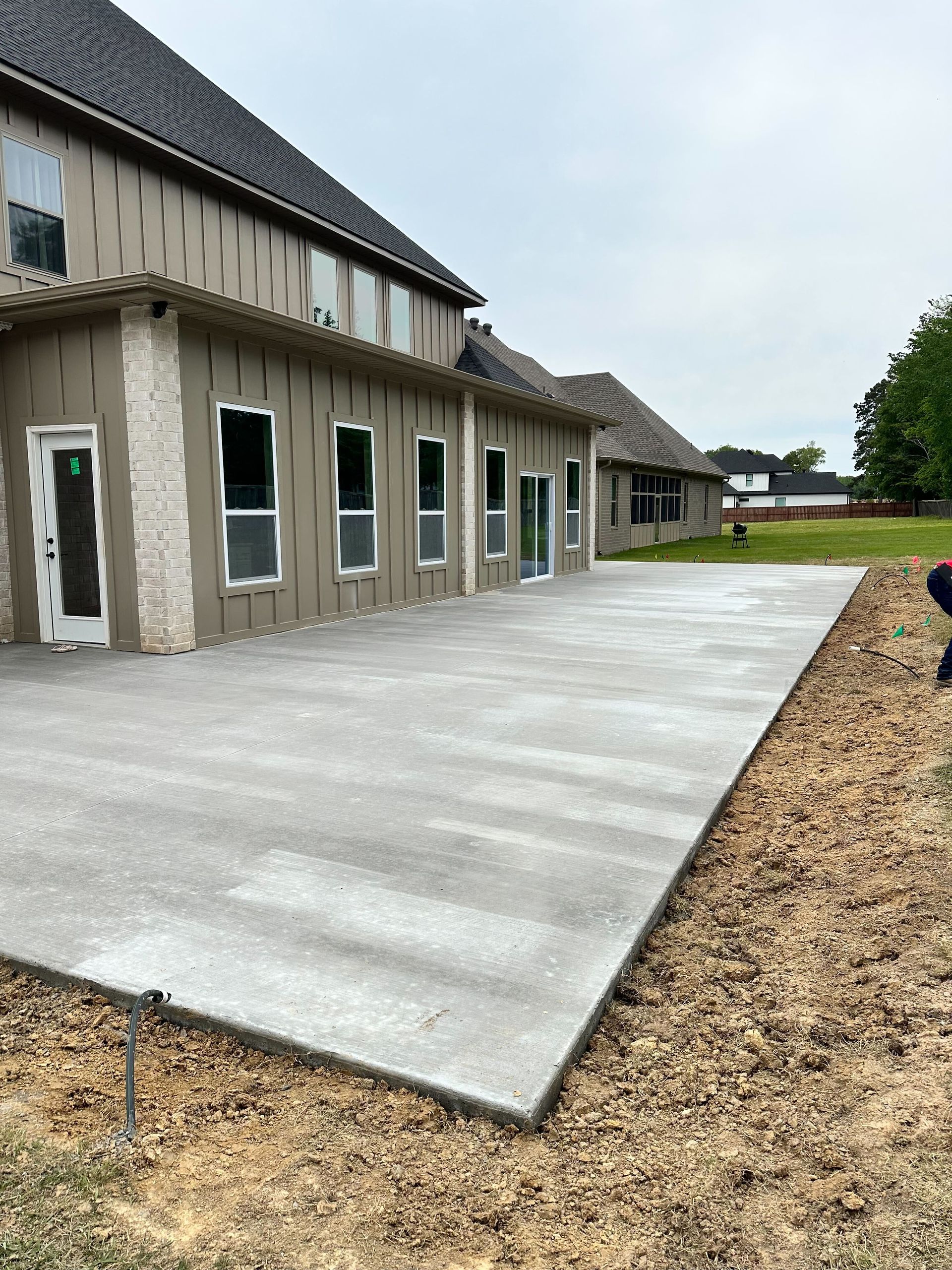 A large house with a concrete driveway in front of it.