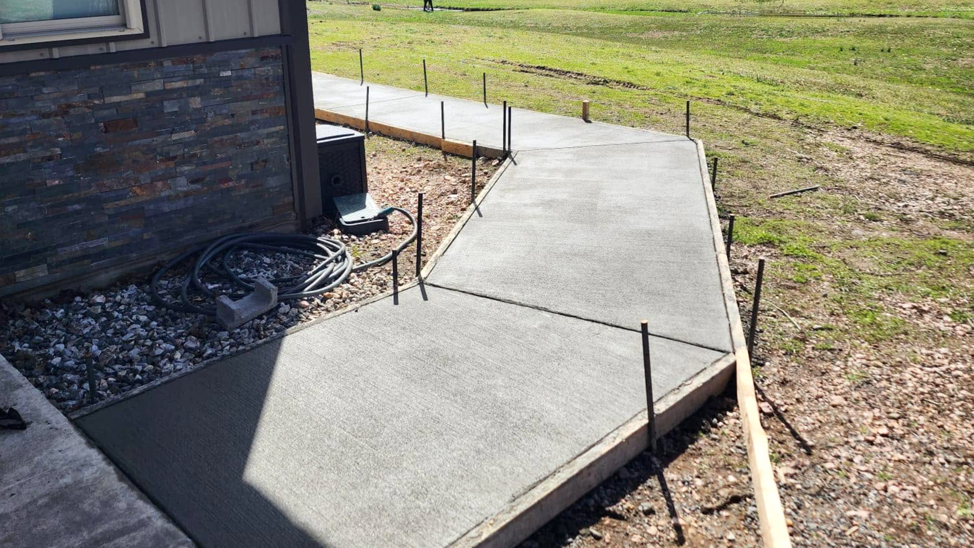 New concrete front entry walkway at a Little Rock area home with a broom finish
