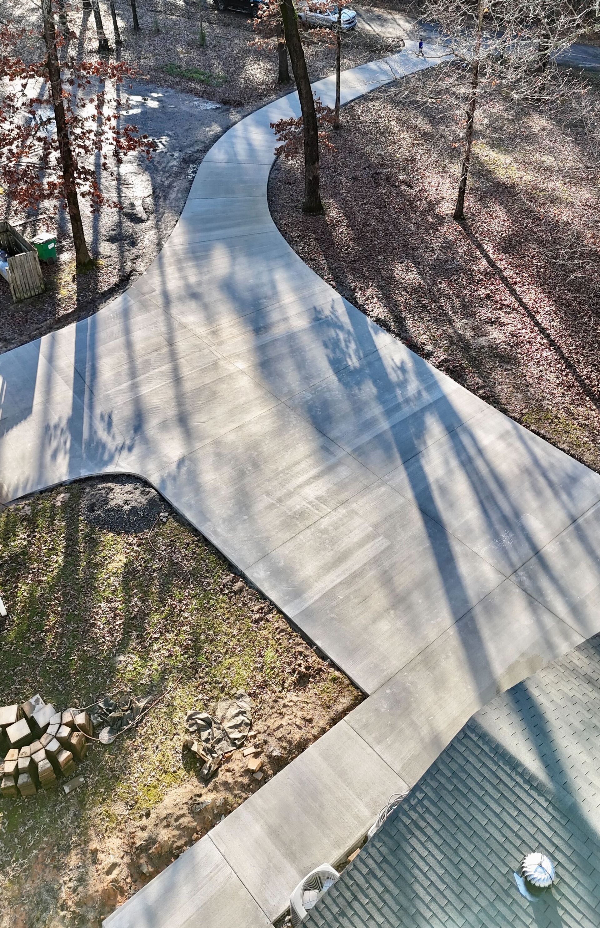 An aerial view of a concrete walkway in the woods.