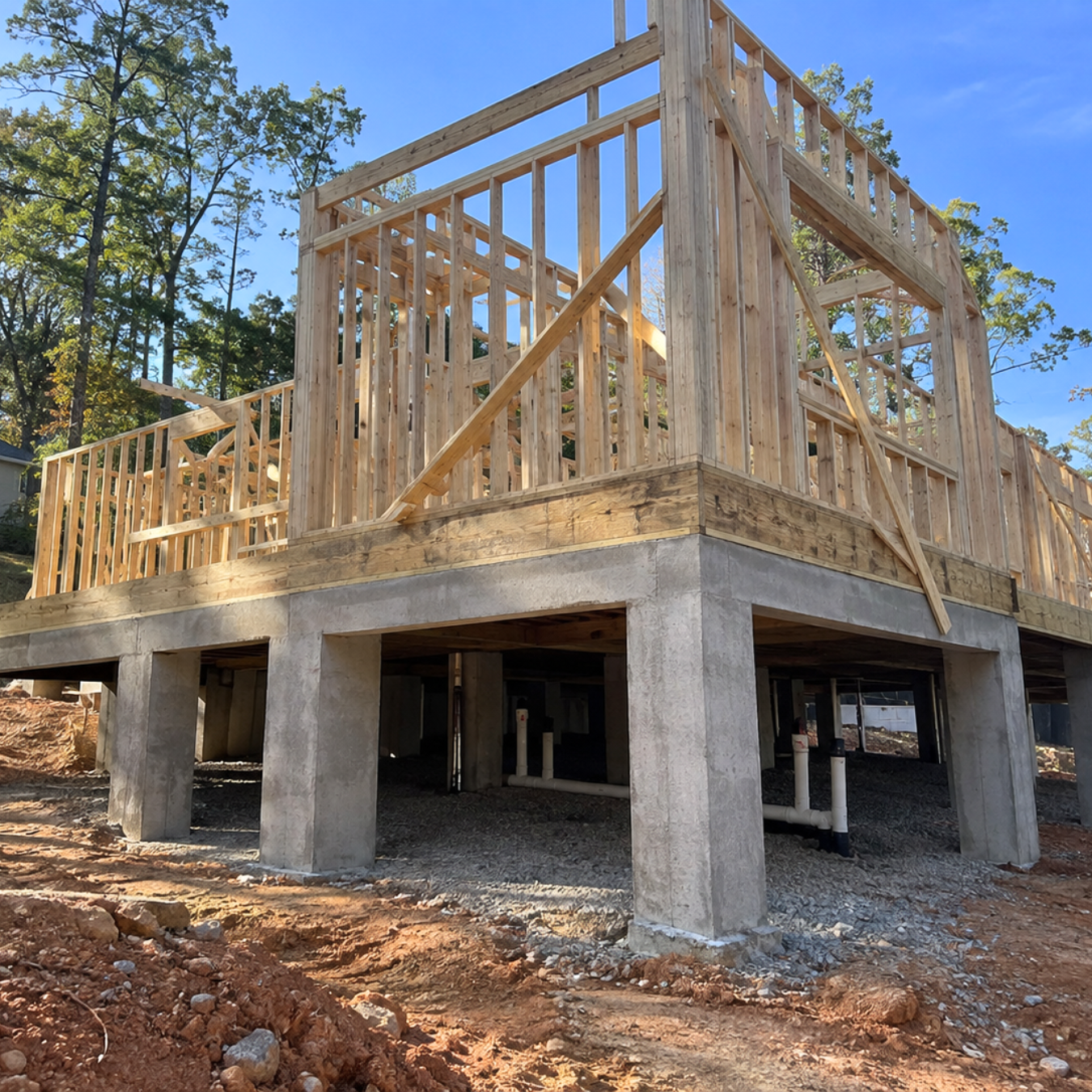 Pier and beam foundation with concrete piers and wood beams elevating a house above the ground