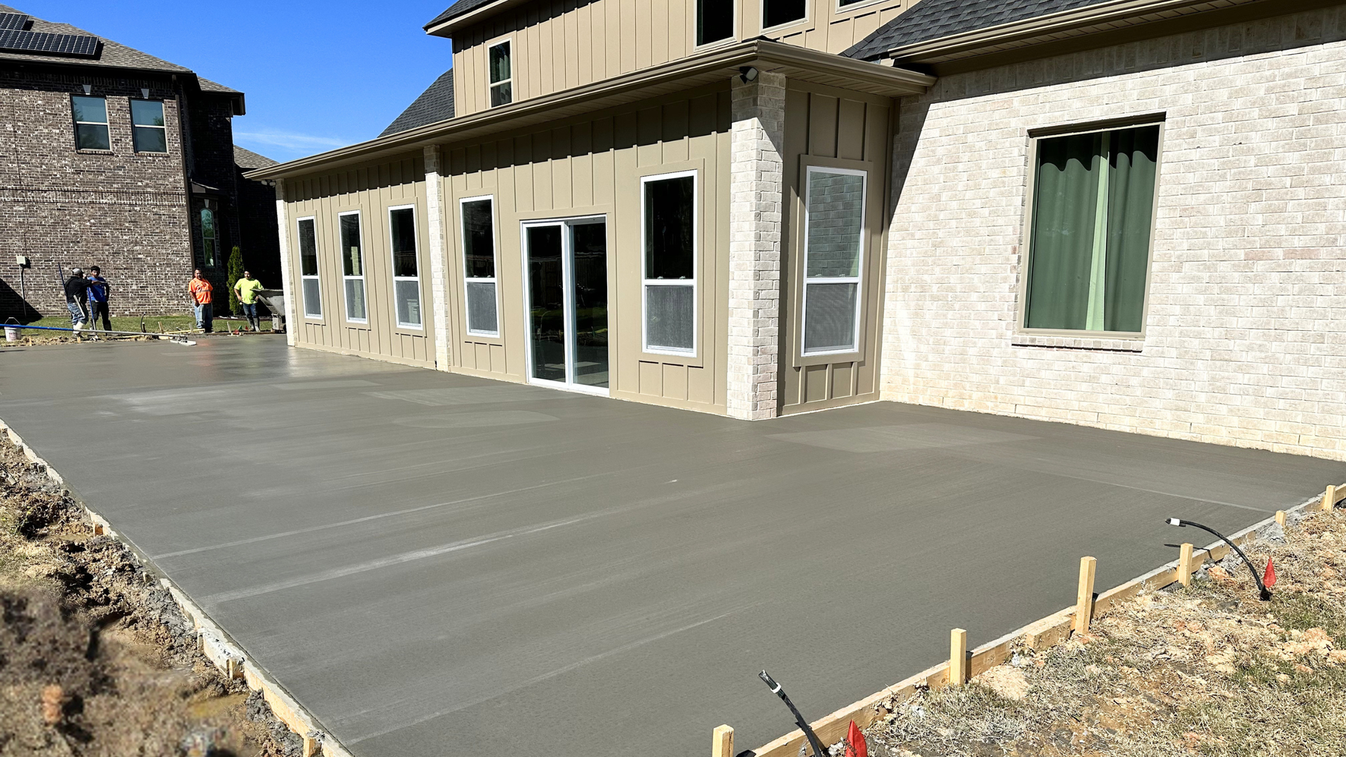 Concrete driveway being finished under moderate fall weather in Central Arkansas