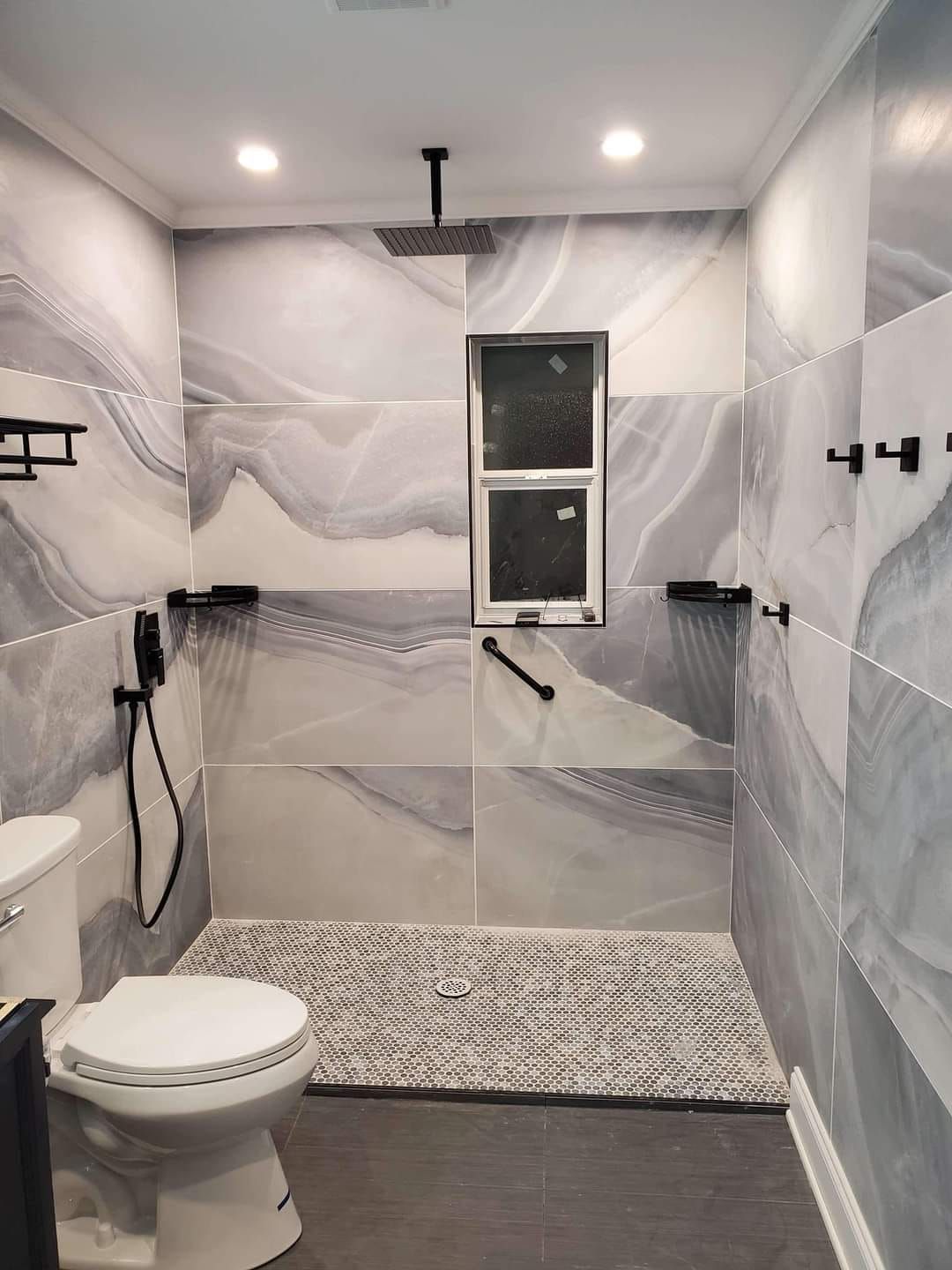 A bathroom with a toilet and a walk in shower.