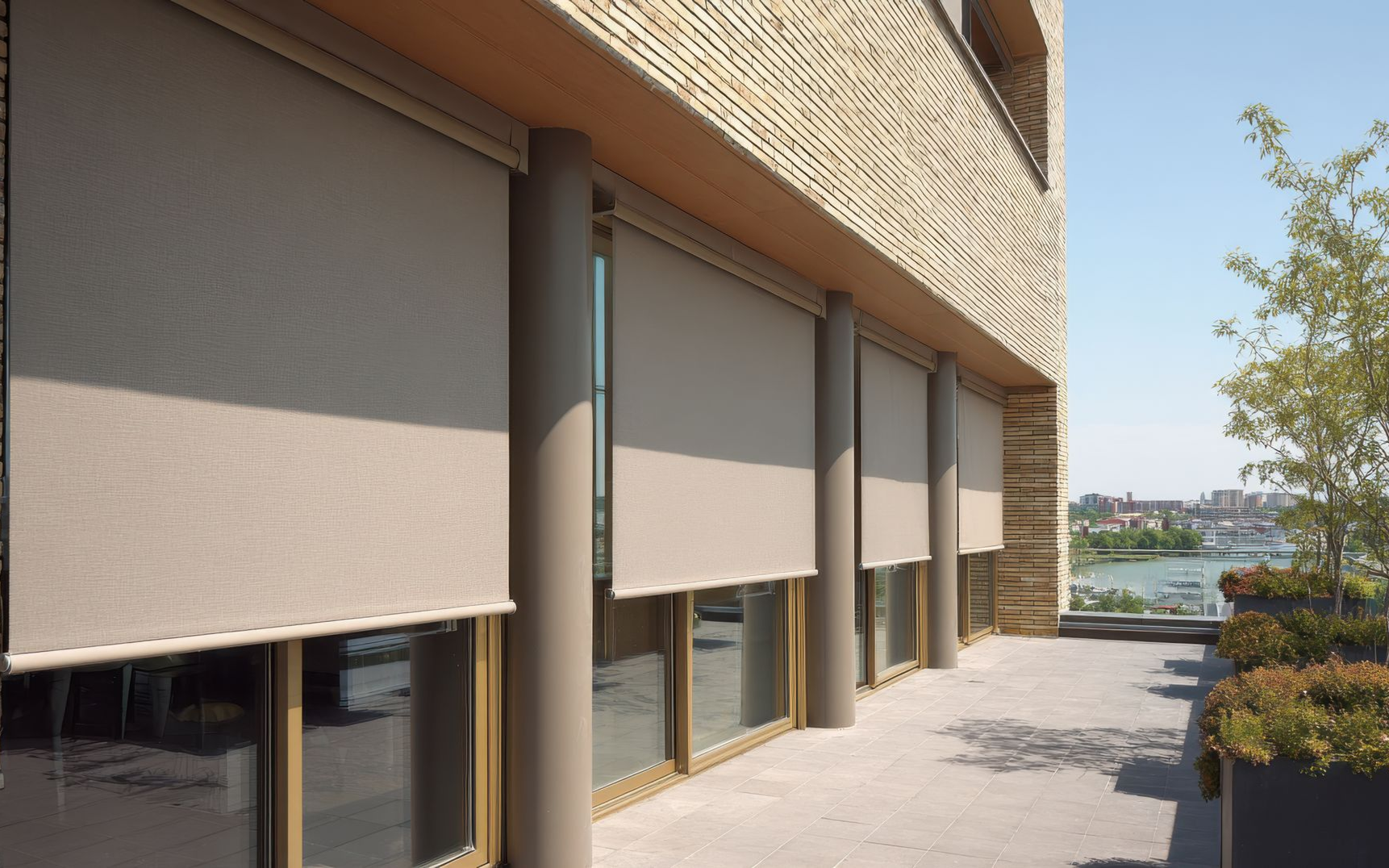 A ground-level view of a modern building exterior featuring a black roller shade over a glass door and wood paneling.