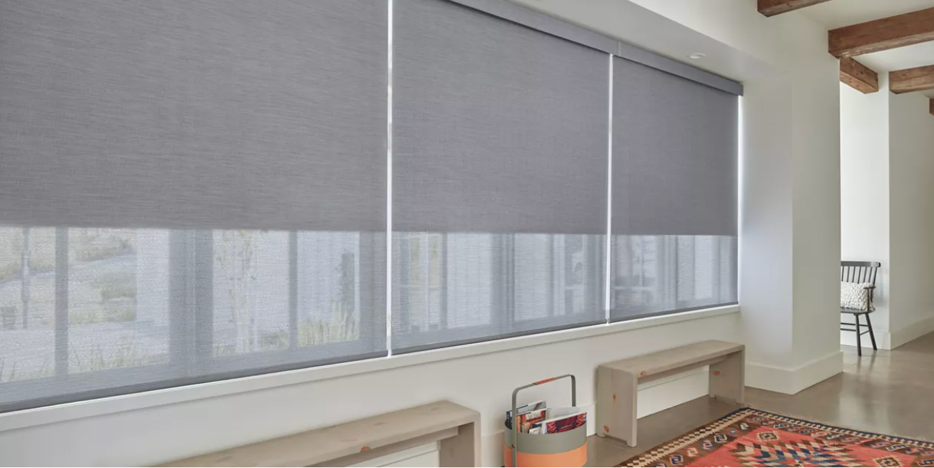 Hunter Douglas Designer Roller shades covering a window in a minimalist home.
