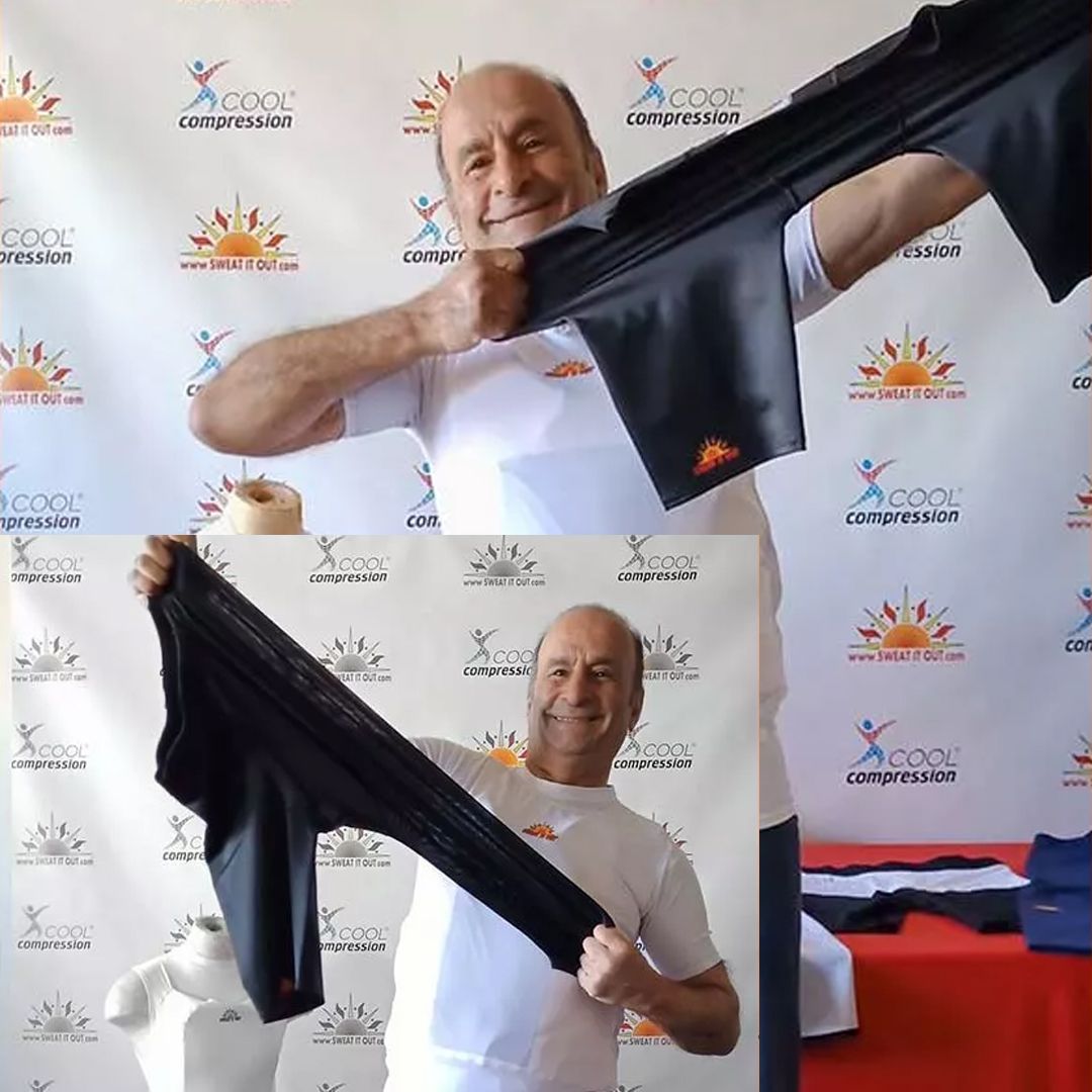 Man holding black compression clothing; smiling, in front of a backdrop with a sun logo.