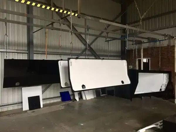 A Warehouse With A Lot Of Boxes Hanging From The Ceiling — Hunter Powder & Paints In Port Stephens, NSW