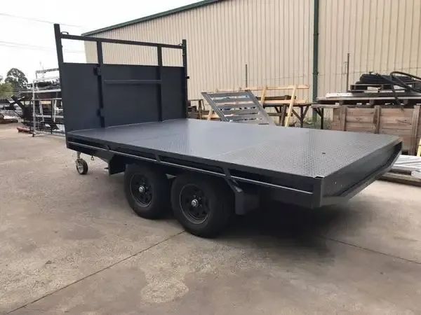 A Flatbed Trailer Is Parked In Front Of A Building — Hunter Powder & Paints In Singleton, NSW