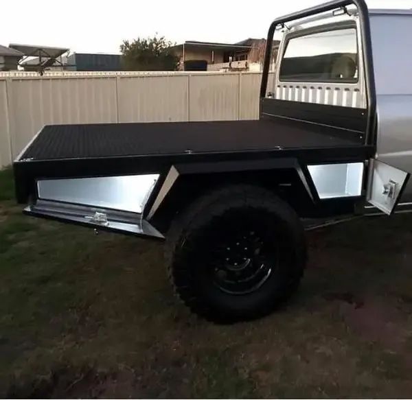 A Silver Truck With A Black Bed Is Parked In Front Of A White Fence — Hunter Powder & Paints In Scone, NSW