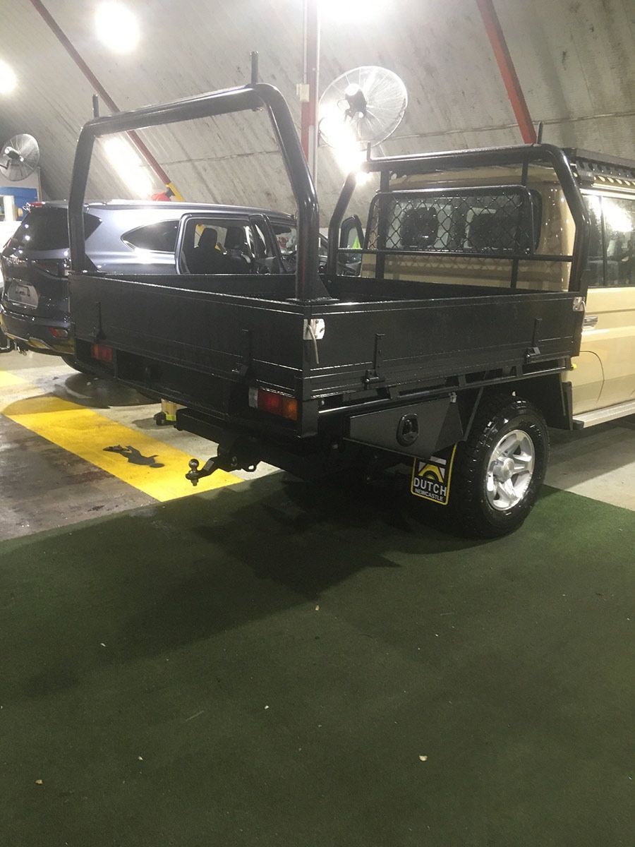 A Truck With A Roof Rack Is Parked In A Garage — Hunter Powder & Paints In Mid North Coast, NSW