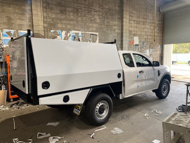 A White Truck With A Canopy Is Parked In A Garage — Hunter Powder & Paints In Mid North Coast, NSW