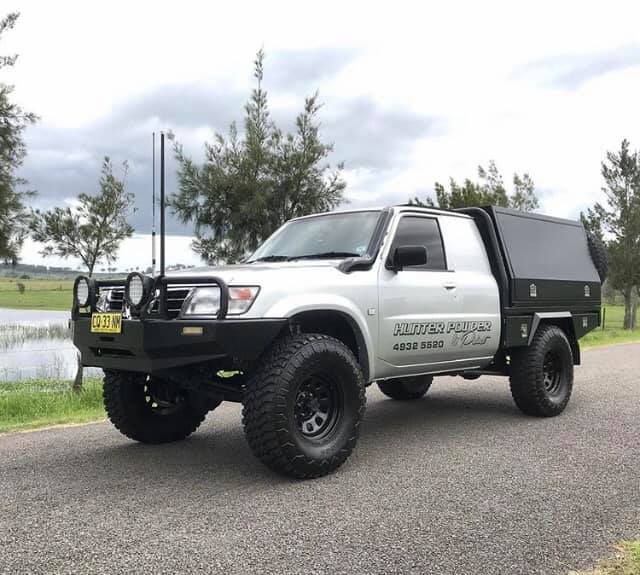 A White Truck With A Black Canopy Is Parked On The Side Of The Road — Hunter Powder & Paints In Rutherford, NSW