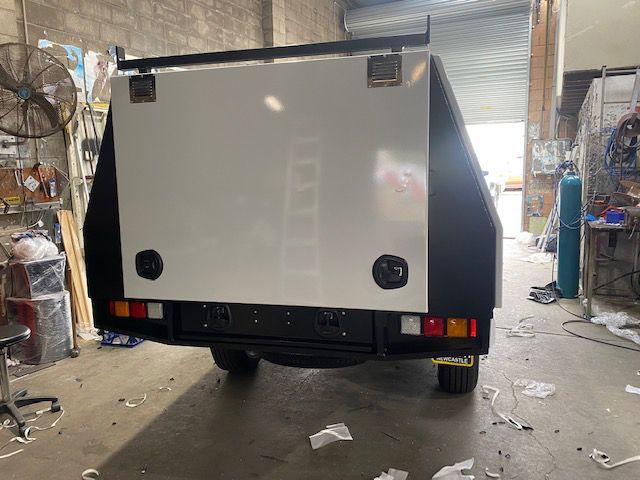 A White Canopy Is Sitting In A Garage Next To A Fan — Hunter Powder & Paints In Central Coast, NSW
