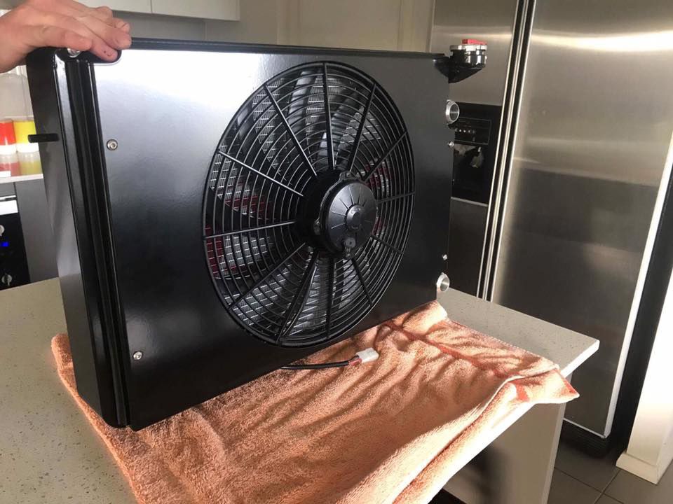 A Fan Holding By A Man — Hunter Powder & Paints In Cessnock, NSW