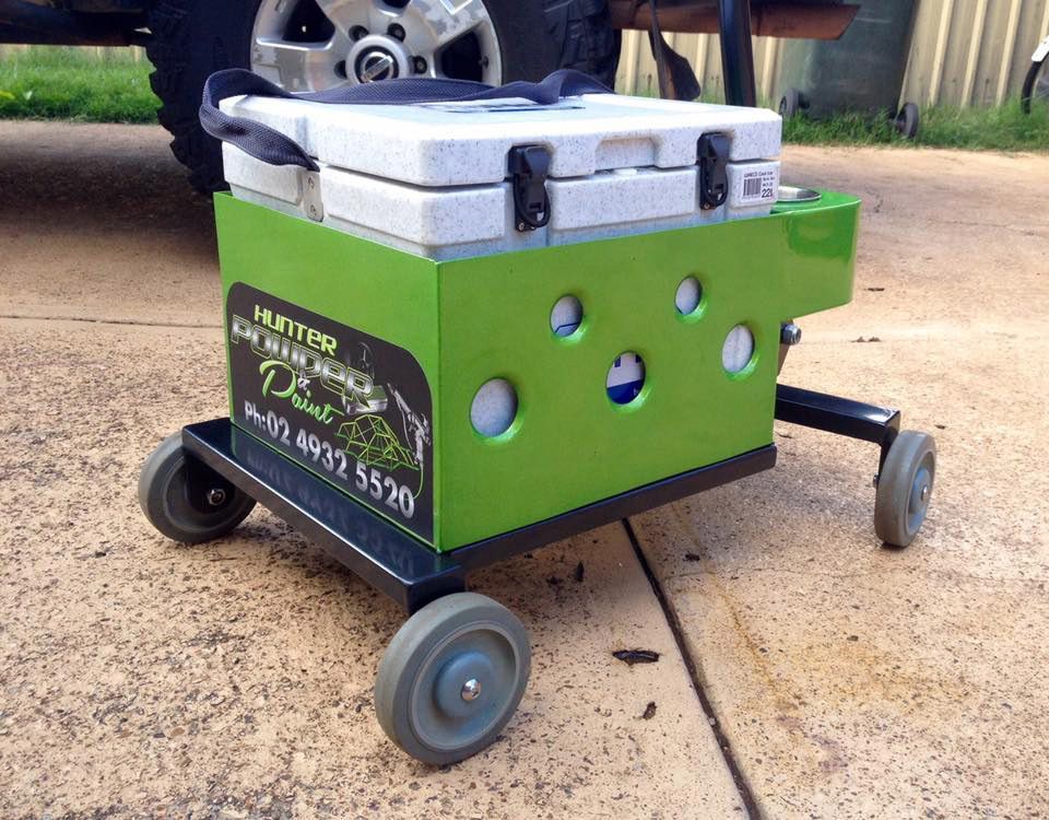 A Green Cooler With Wheels Sits On The Sidewalk Next To A Truck — Hunter Powder & Paints In Newcastle, NSW