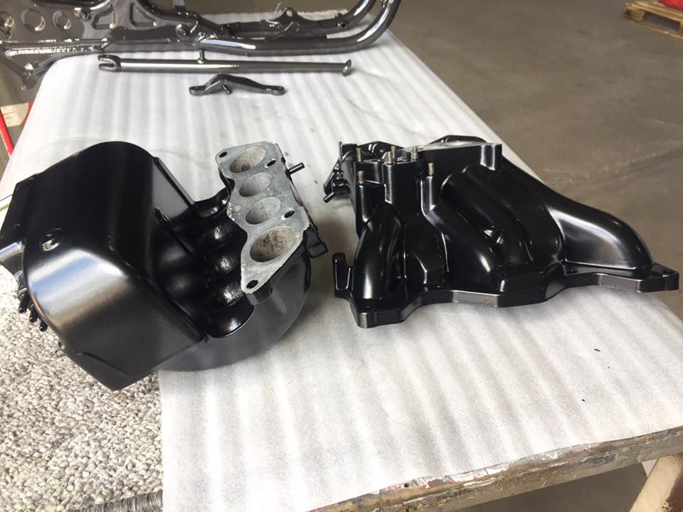 A Black Engine Is Sitting On A White Table — Hunter Powder & Paints In Lake Macquarie, NSW