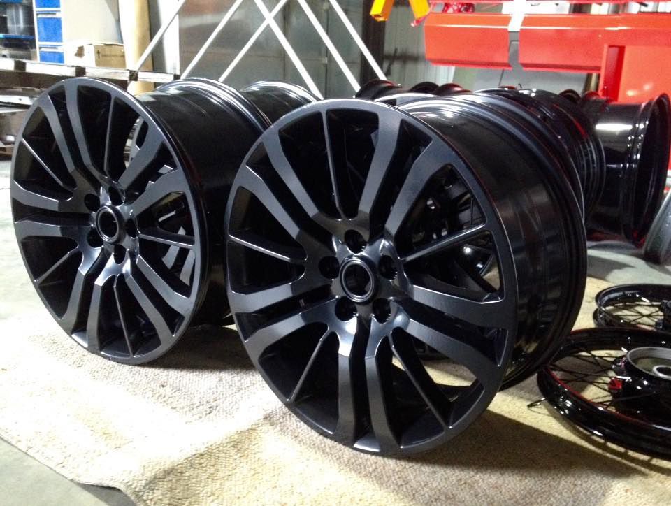 A Row Of Black Wheels Are Sitting On A Table — Hunter Powder & Paints In Lake Macquarie, NSW