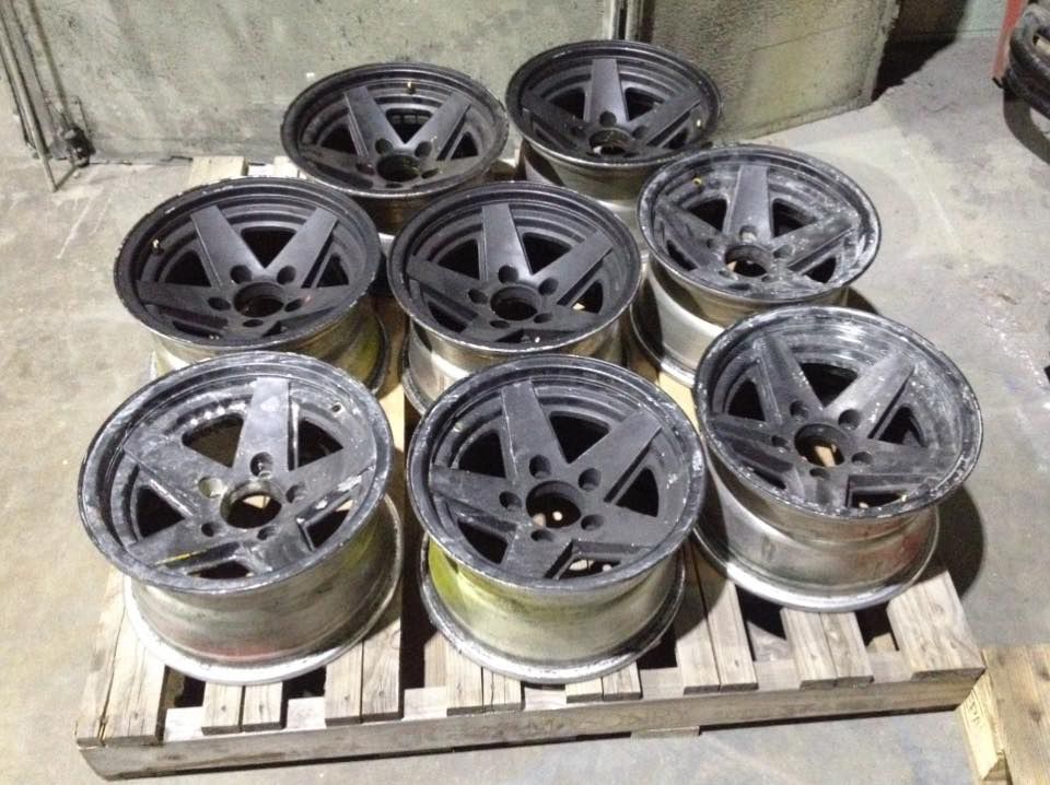 A Bunch Of Wheels Are Sitting On A Wooden Pallet — Hunter Powder & Paints In Muswellbrook, NSW