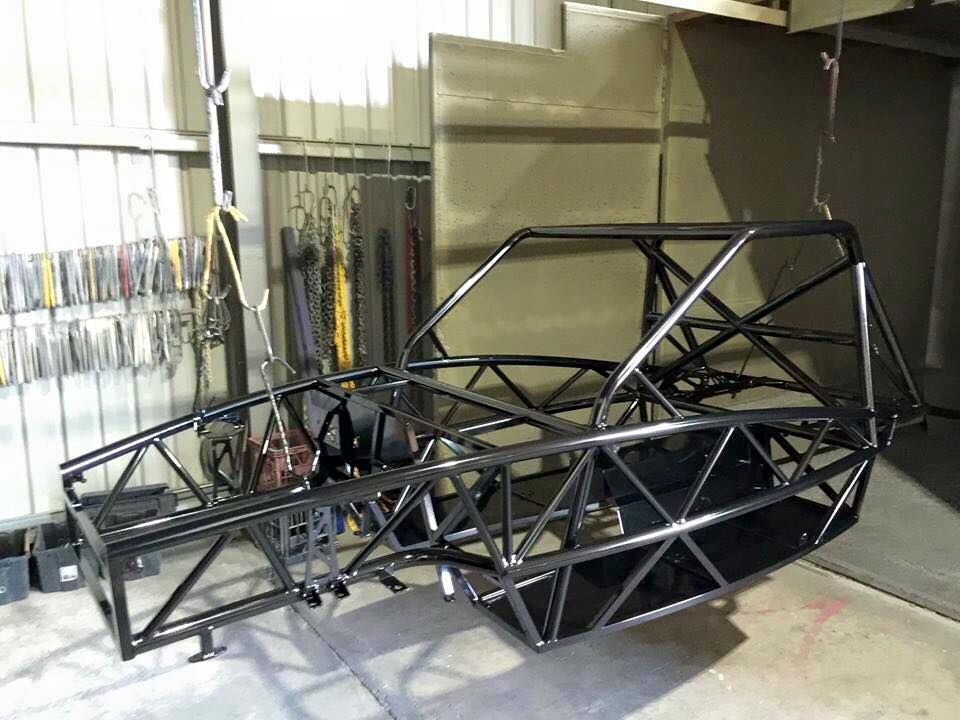 A Metal Frame Of A Vehicle Is Sitting On The Floor In A Garage — Hunter Powder & Paints In Central Coast, NSW