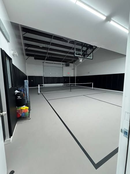 There is a tennis court in the middle of the room.